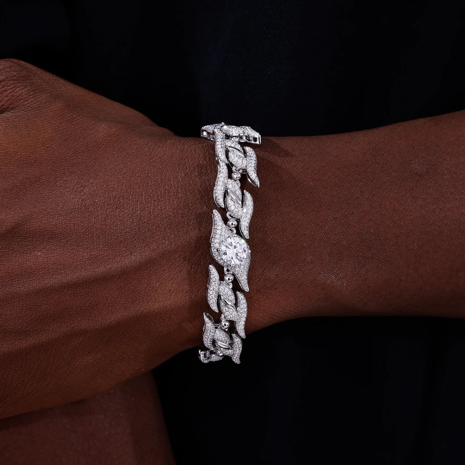 Silver bracelet on a wrist with a dark background