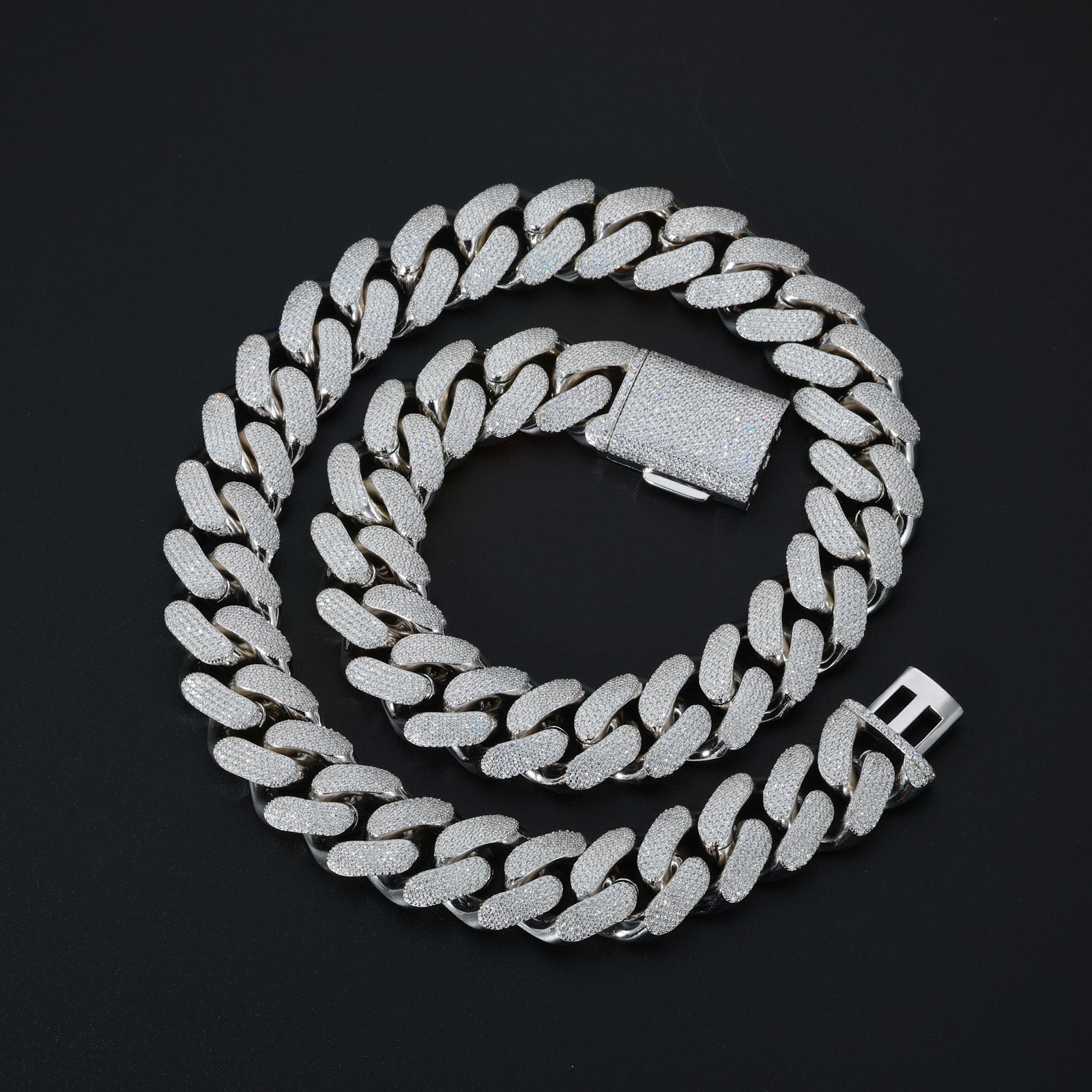 Silver chain necklace on a black background