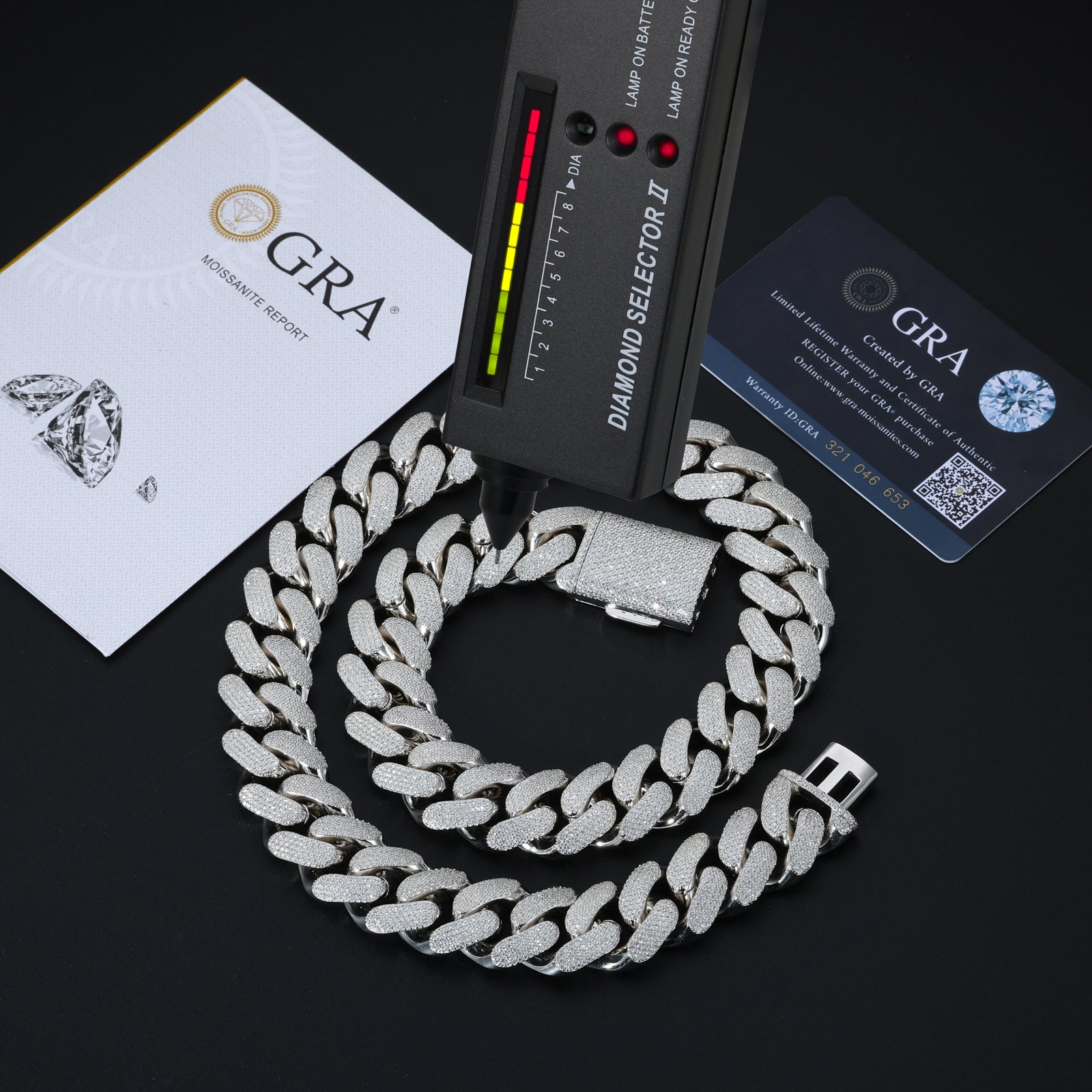 Silver chain necklace with diamond selector tool and GRA certification on a black background