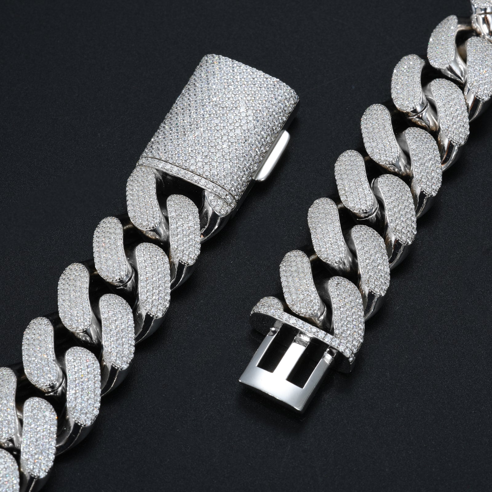 Silver chain bracelet with diamond-like stones on a black background