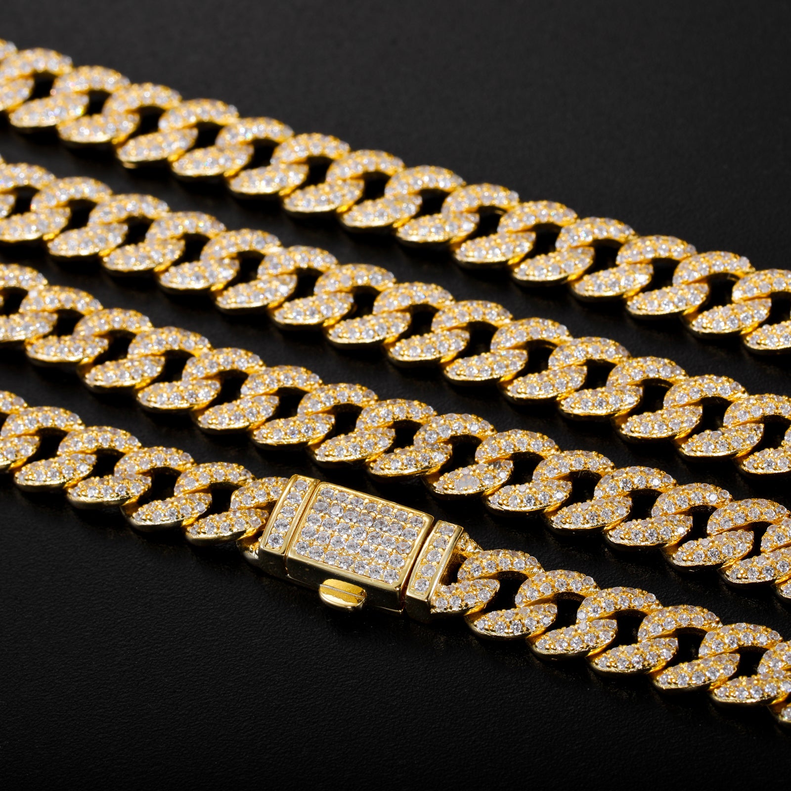 Gold chain necklace with diamond-like stones on a black background