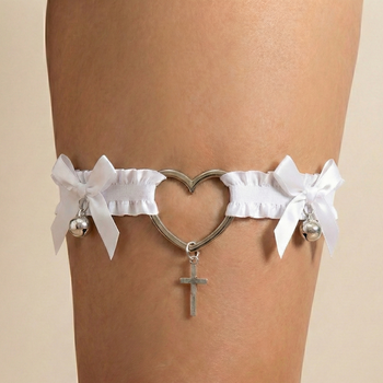 White garter with heart design and cross charm on a beige background