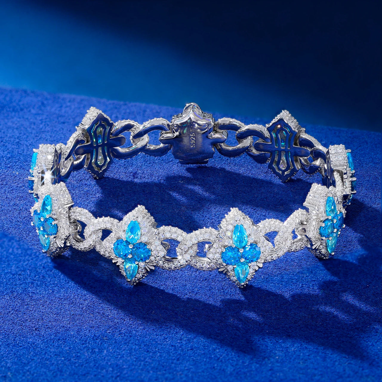 Silver tiara with blue gemstones on a blue background