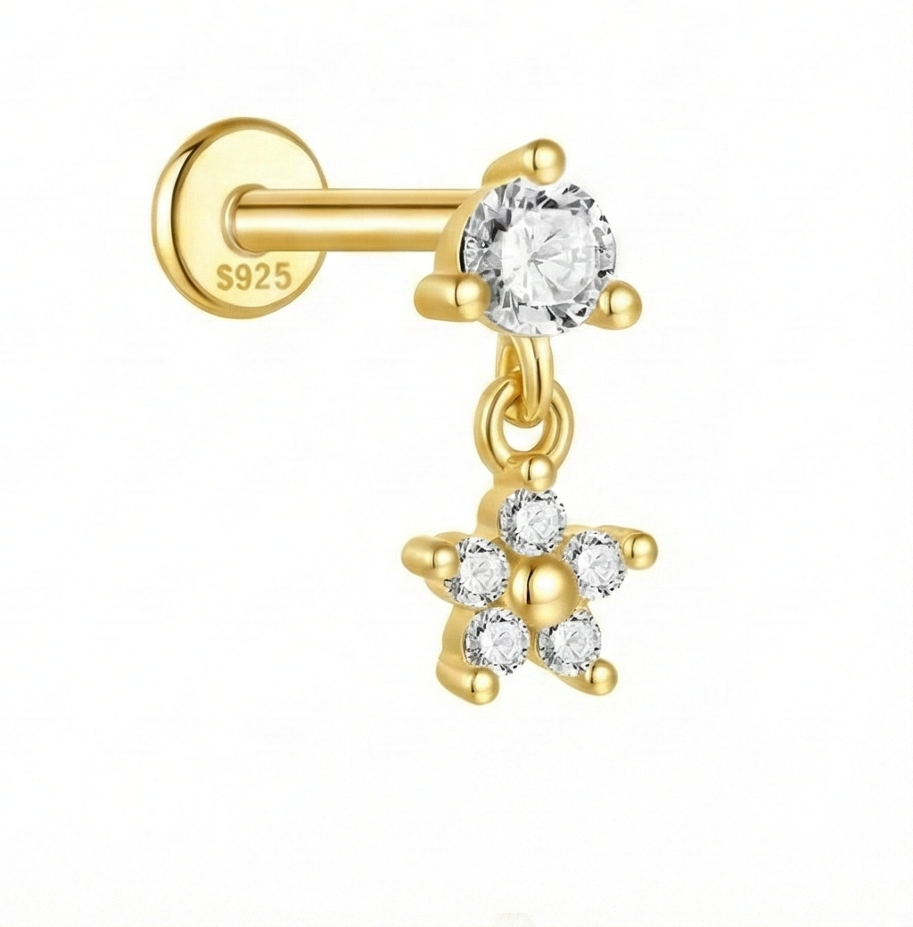 Gold earring with a clear gemstone on a white background