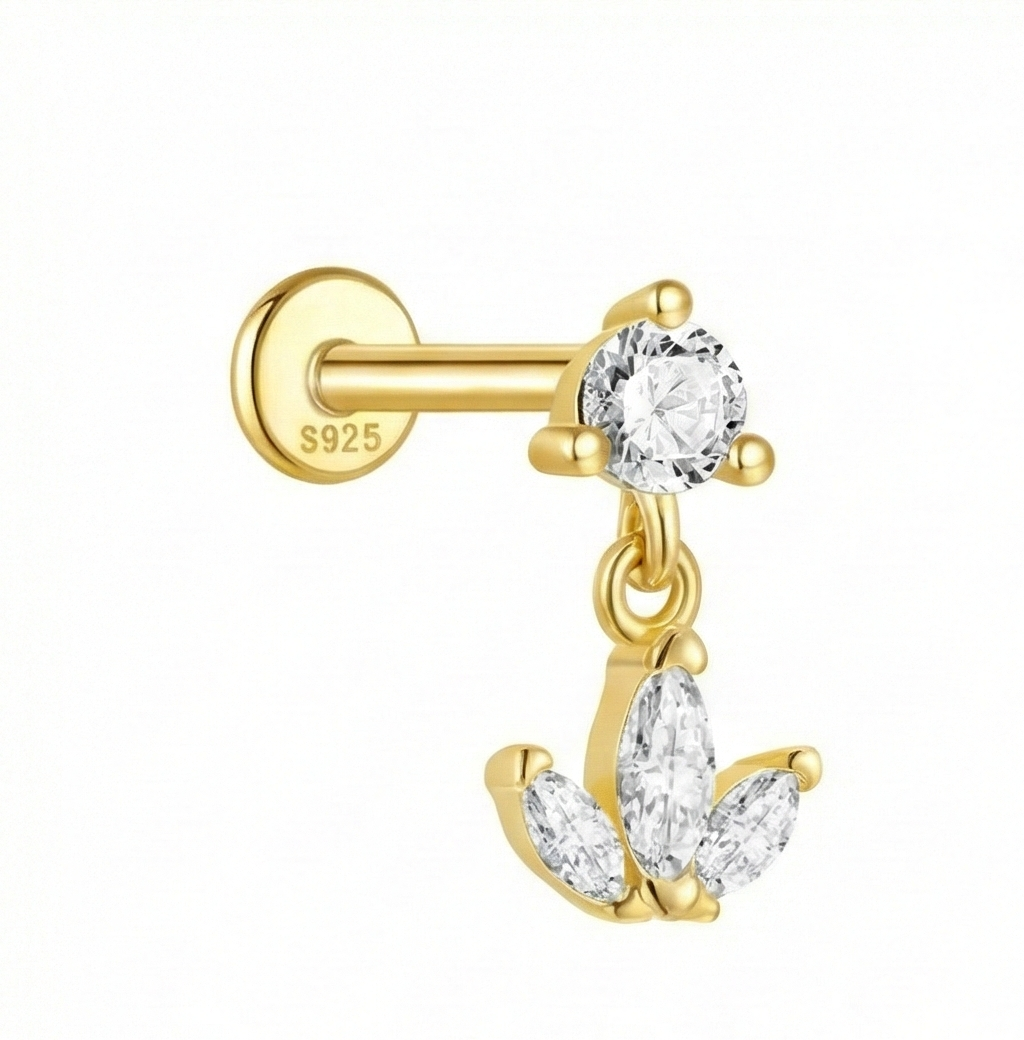 Gold earring with clear gemstones on a white background