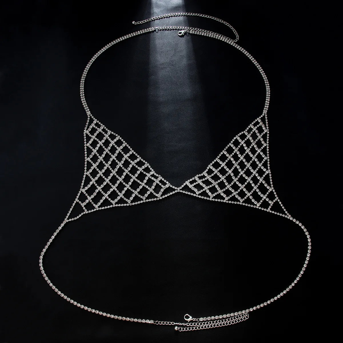 Black bikini top with silver embellishments on a plain background