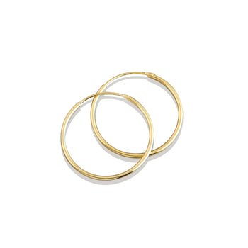 Gold hoop earrings on a white background