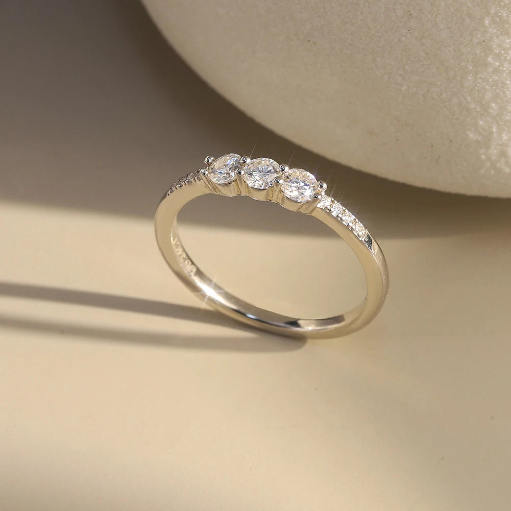 CLASSIC ROUND MOISSANITE THREE-STONE BAND RING IN STERLING SILVER