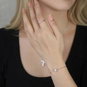 CLASSIC ROUND MOISSANITE THREE-STONE BAND RING IN STERLING SILVER