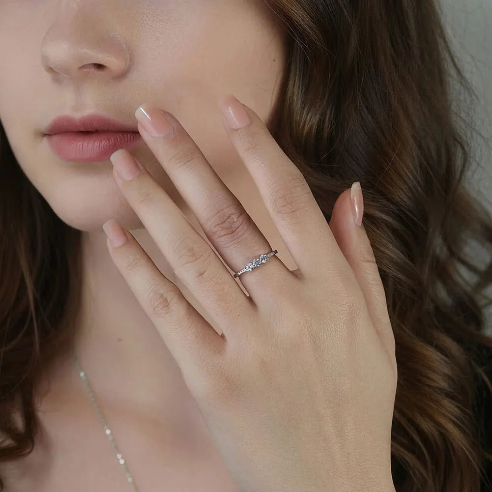 CLASSIC ROUND MOISSANITE THREE-STONE BAND RING IN STERLING SILVER