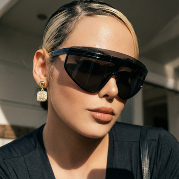 Person wearing black sunglasses and a black top outdoors