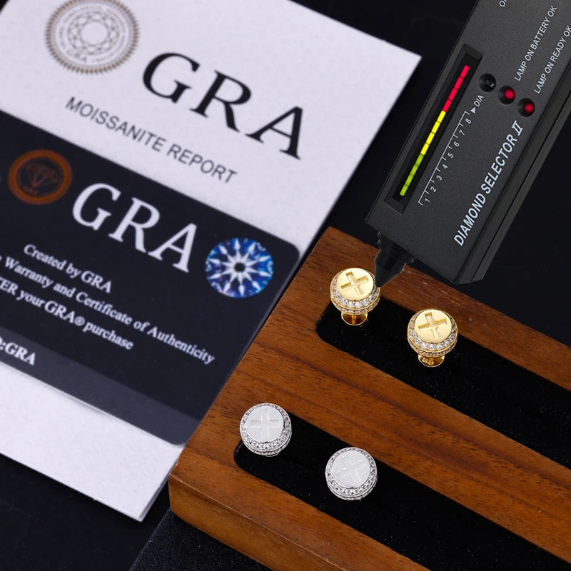 Diamond earrings on a stand with a diamond tester and GRA moissanite report card.