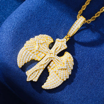 Gold pendant necklace on a blue fabric background