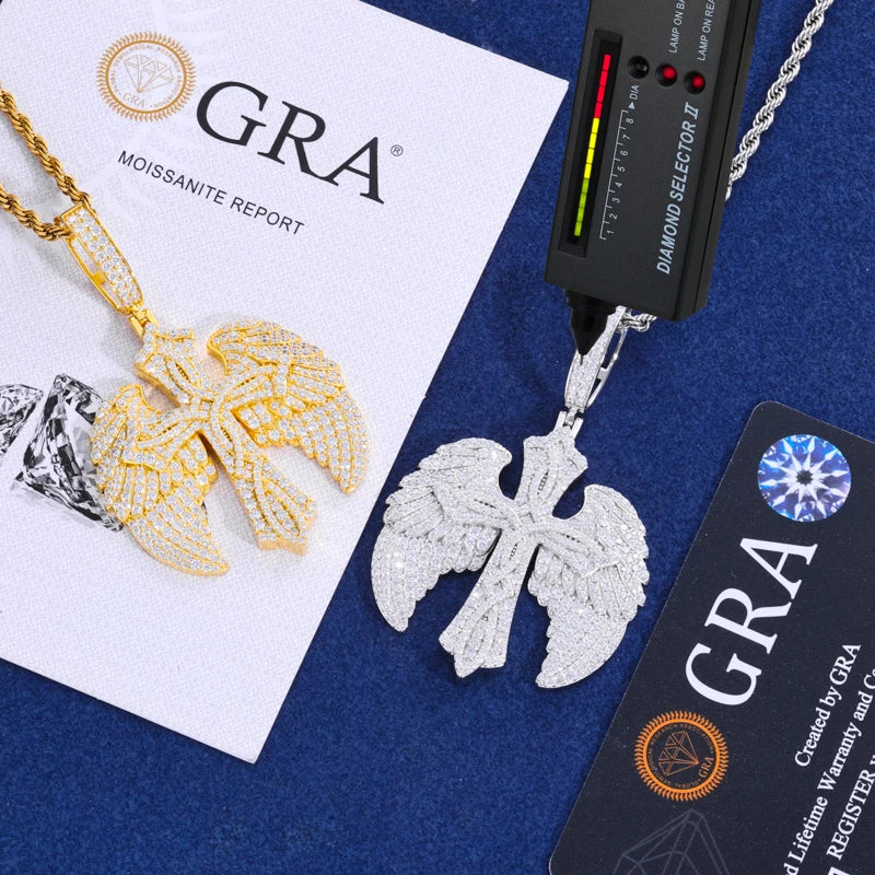 Gold and silver leaf-shaped pendants on a blue surface with GRA diamond testing equipment.