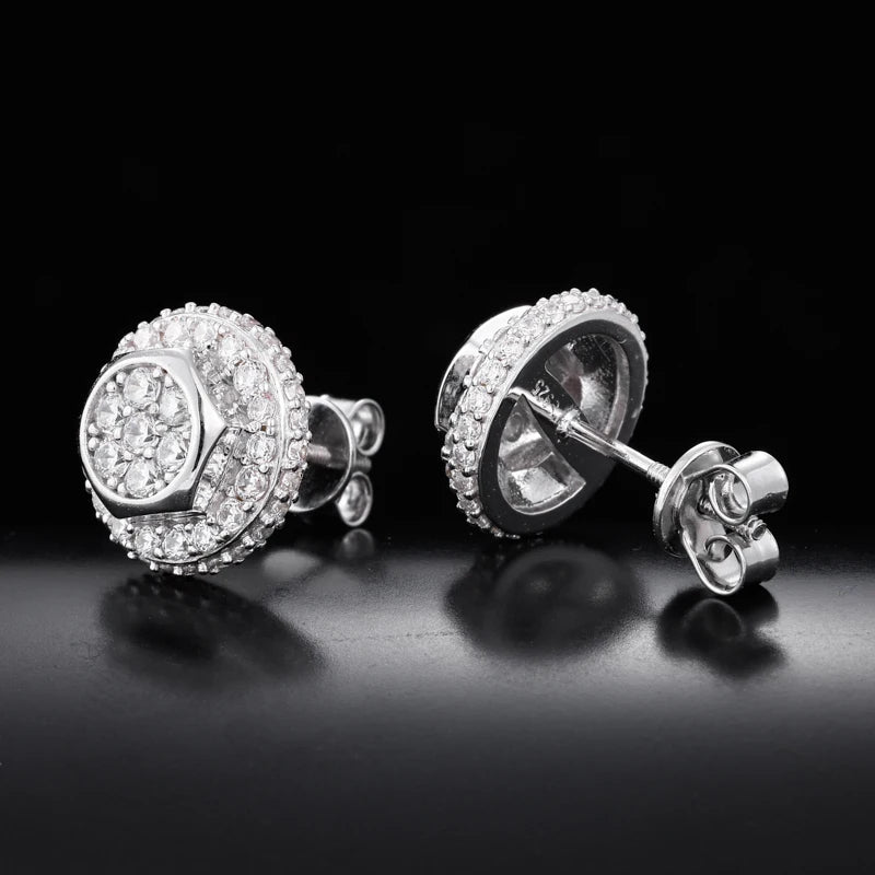 Pair of silver stud earrings with clear gemstones on a black background