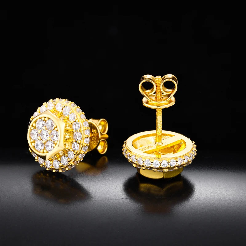 Pair of silver earrings with diamond-like stones on a black background