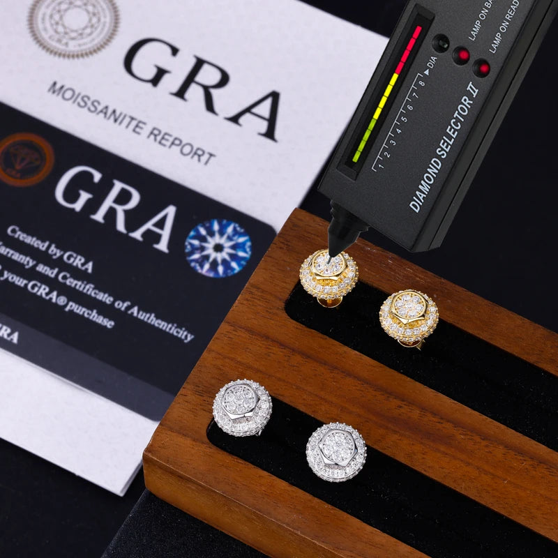 Diamond earrings on a wooden stand with a diamond selector tool and GRA report in the background.