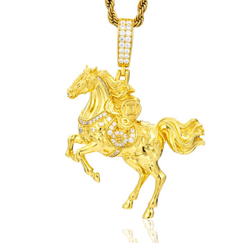 Gold horse pendant with chain on a white background