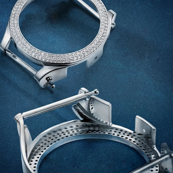 Two silver watch cases on a blue textured background