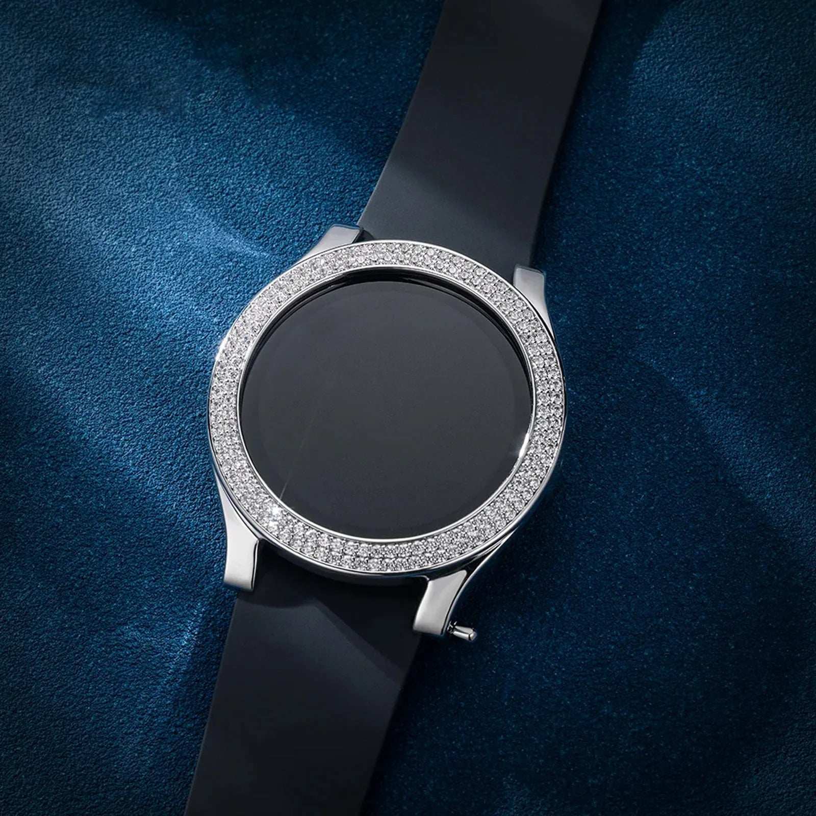 Smartwatch with a black strap and diamond-studded bezel on a blue background