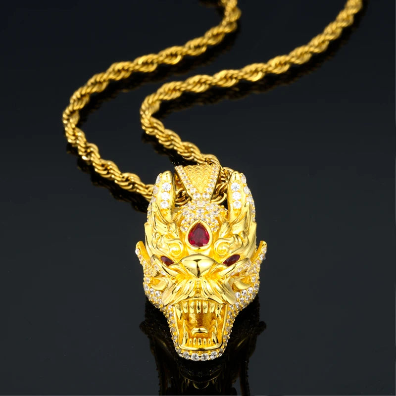 Gold wolf head pendant necklace with red gemstone on a black background