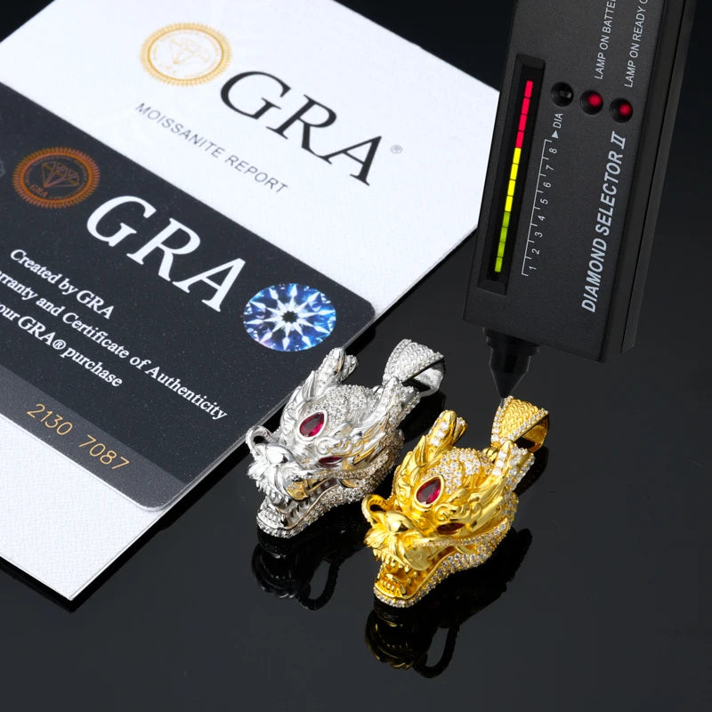 Two dragon-shaped pendants, one gold and one silver, with a diamond selector and GRA certification in the background.