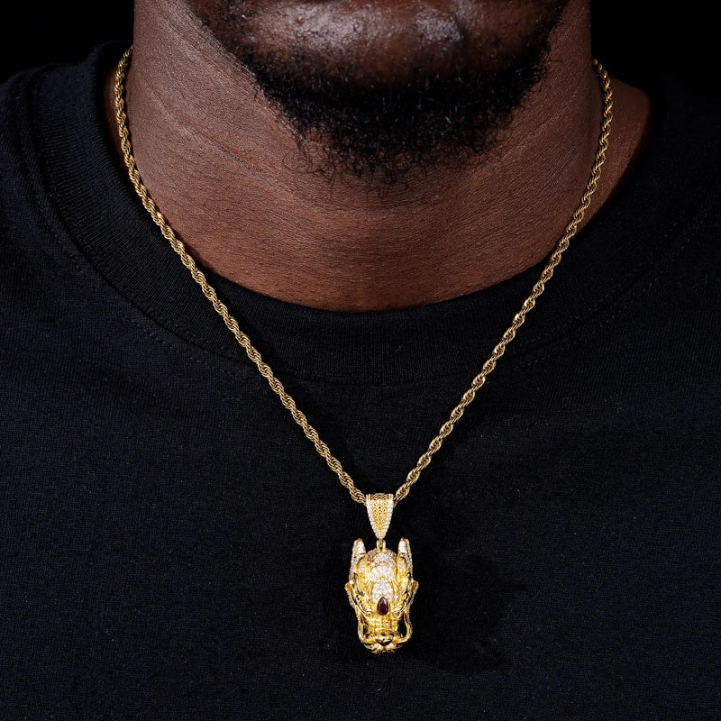 Gold necklace with a detailed pendant on a black background