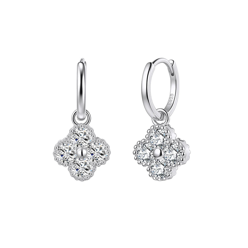 Pair of silver earrings with floral design on a white background