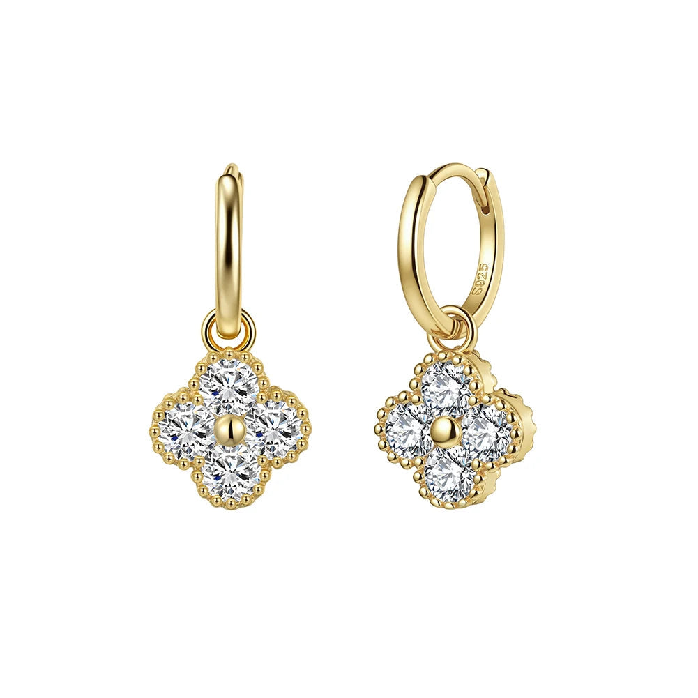 Gold earrings with clear gemstones on a white background, featuring 'Real Sterling 925' stamp.