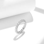 MOISSANITE TENNIS ETERNITY BAND RING WITH SIDE HALO IN STERLING SILVER