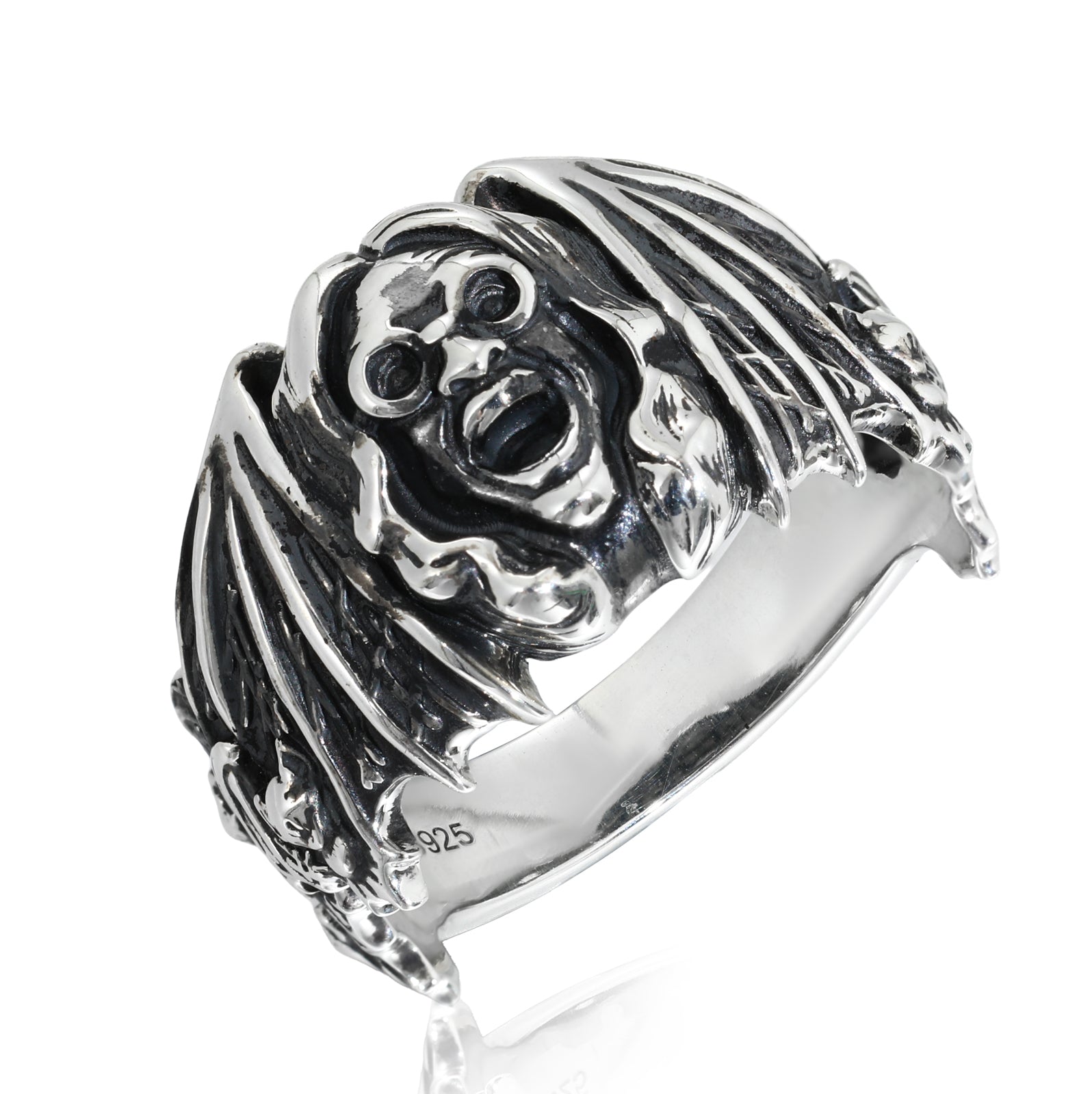 Silver ring with a detailed design on a white background