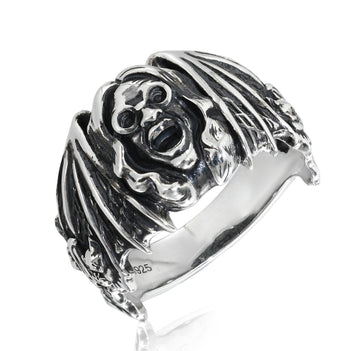Silver ring with a detailed design on a white background