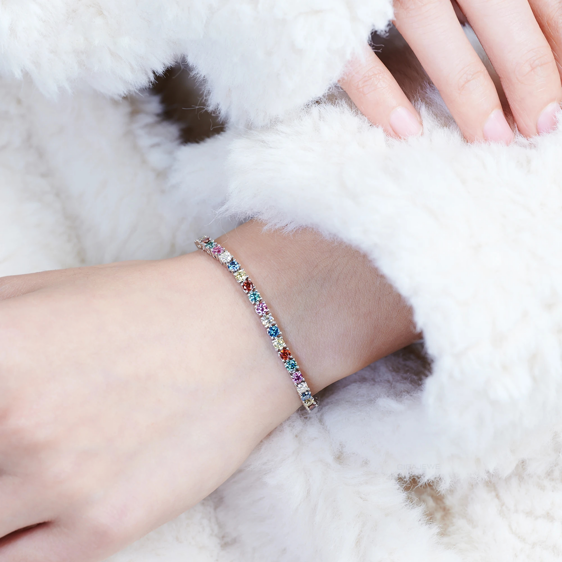 Multicolored beaded bracelet on a wrist with a fluffy white background