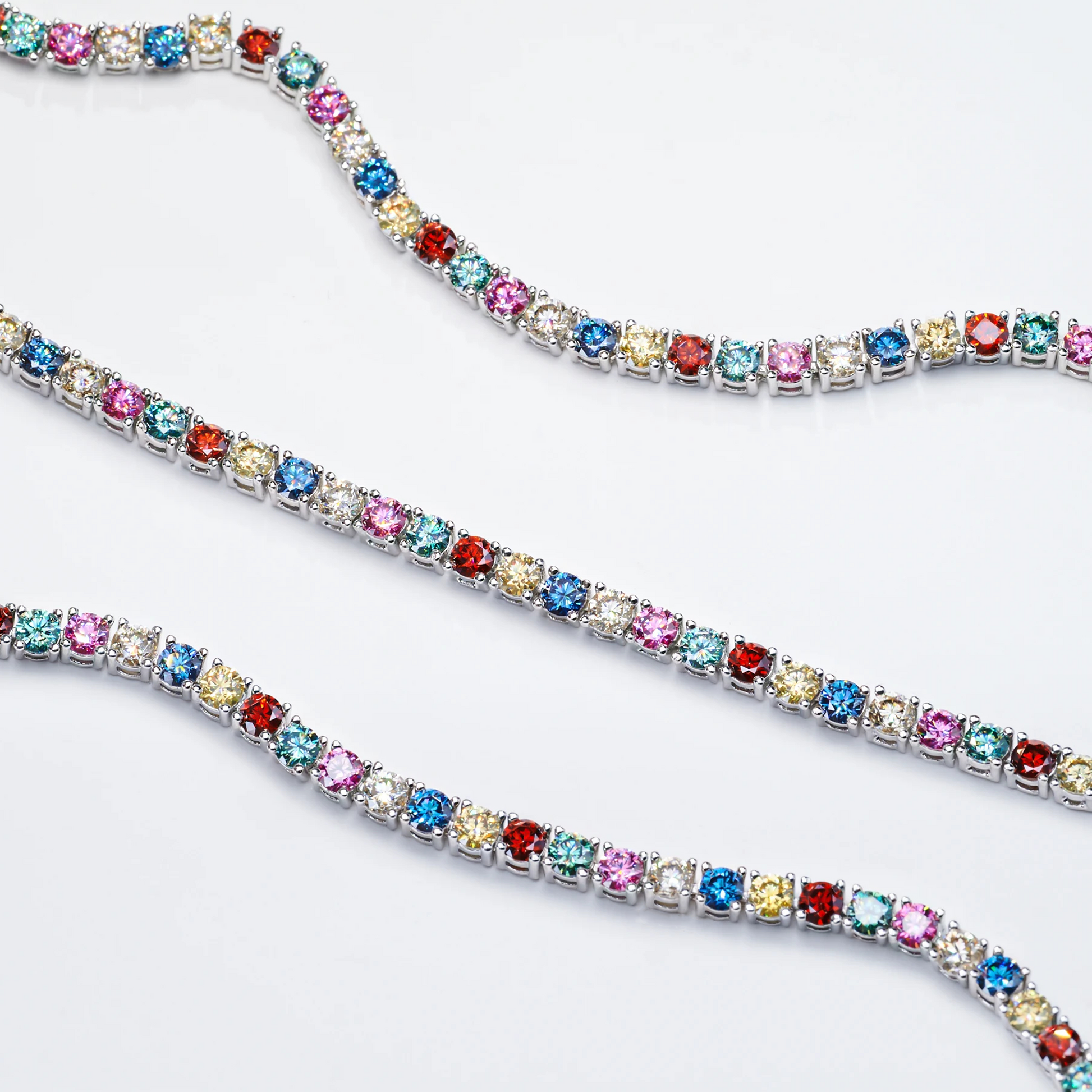 Multicolored gemstone tennis bracelet on a white background