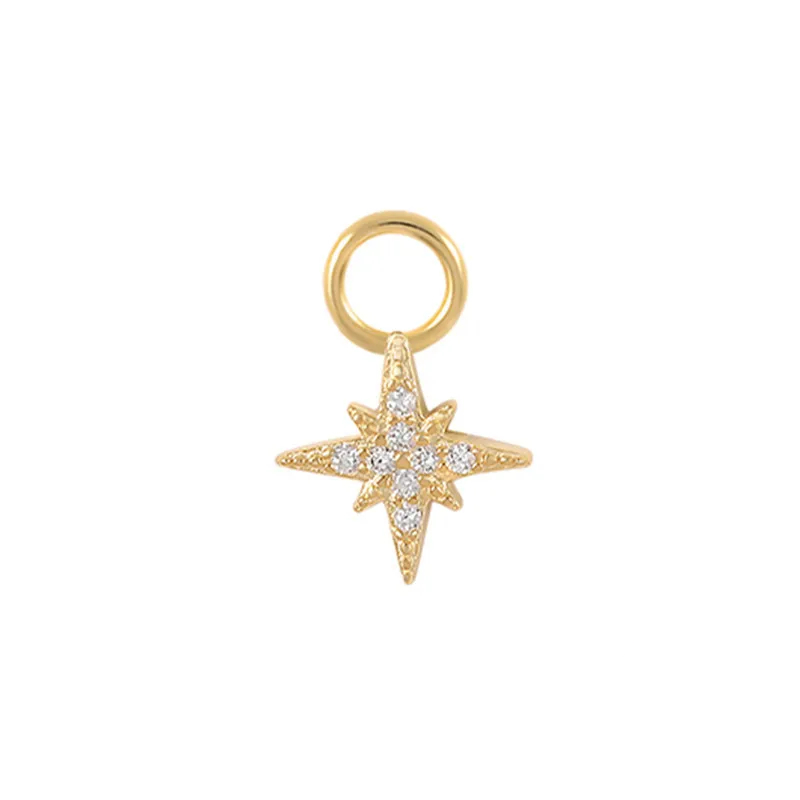 Gold star-shaped charm with embedded stones on a white background