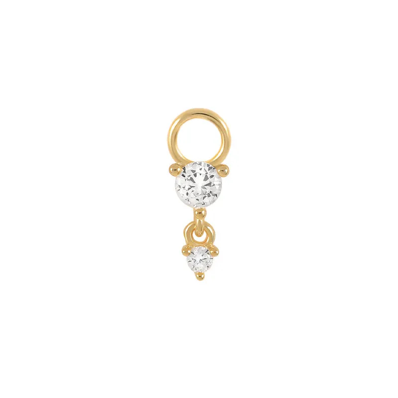 Gold earring with a clear gemstone on a white background