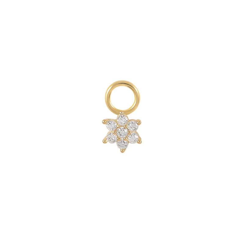 Gold crescent moon charm with embedded stones on a white background