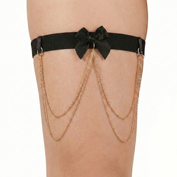 Black garter belt with gold chains on a white background