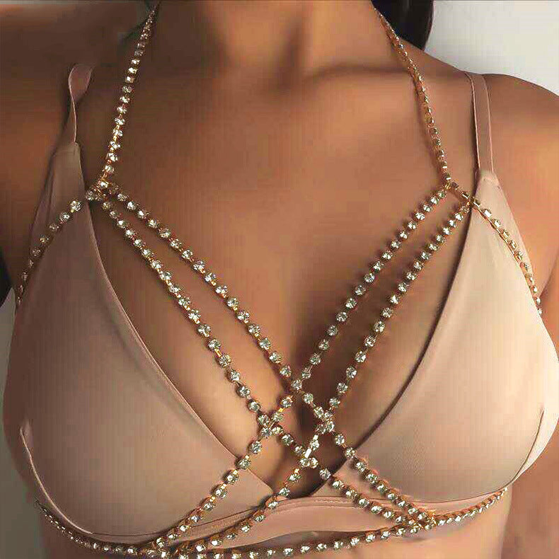 Beige bra with rhinestone detailing on a plain background