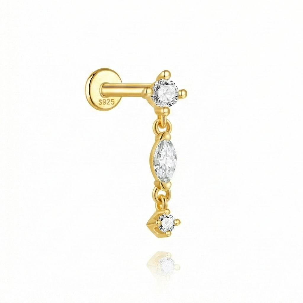 Gold earring with clear gemstones on a white background
