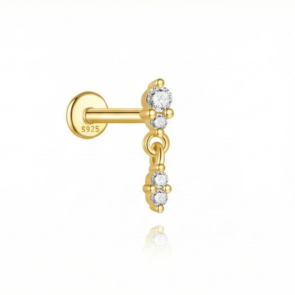 Gold earring with clear gemstones on a white background