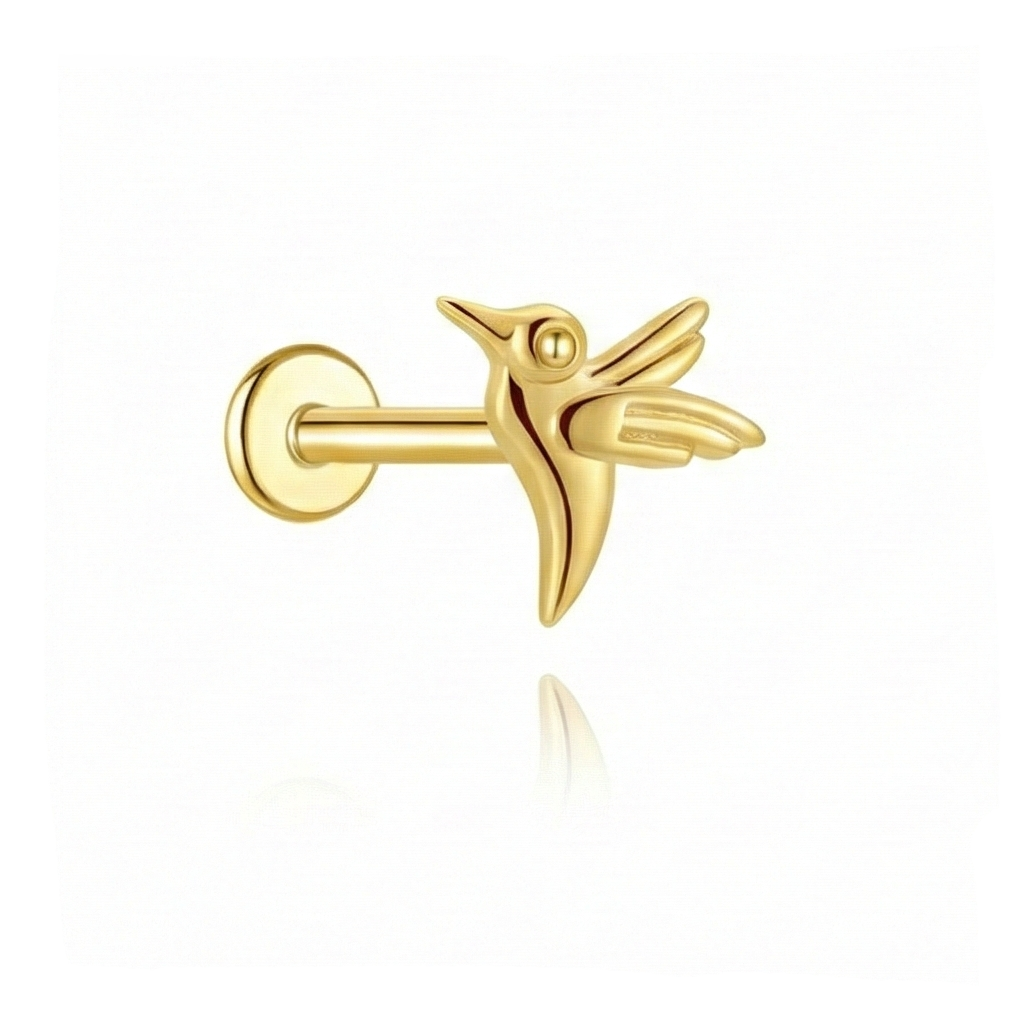 Gold bird-shaped earring on a white background