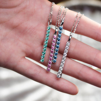 WHITE GOLD PLATED ROUND CUT COLORED MOISSANITE PENDANT IN STERLING SILVER